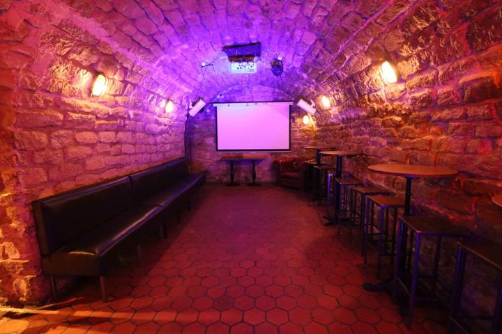 The vaulted stone cellar with projector screen